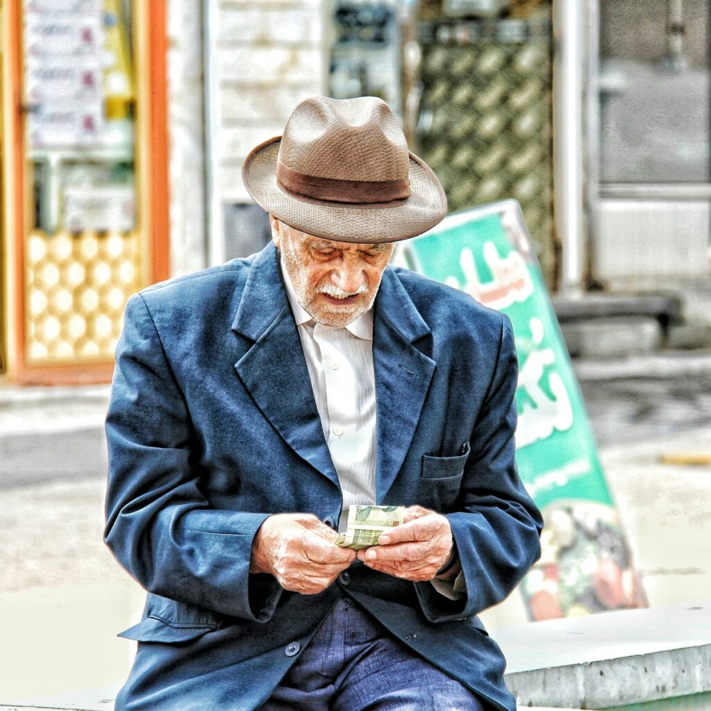 a man in a hat holding a glass of beer