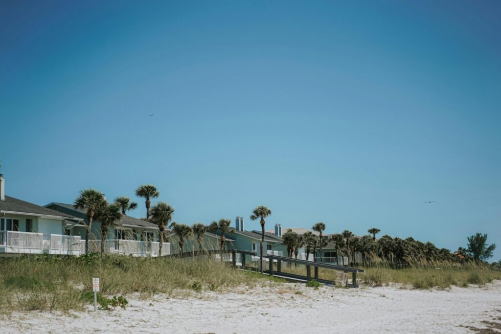 Charming beach homes on Belleair Beach, Florida with a clear blue sky backdrop.